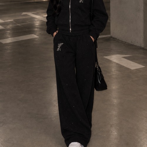 Model wearing M&N Orgullo black rhinestone wide-leg sweatpants
