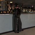 Model wearing M&N Orgullo dark gray rhinestone hoodie on rooftop at night