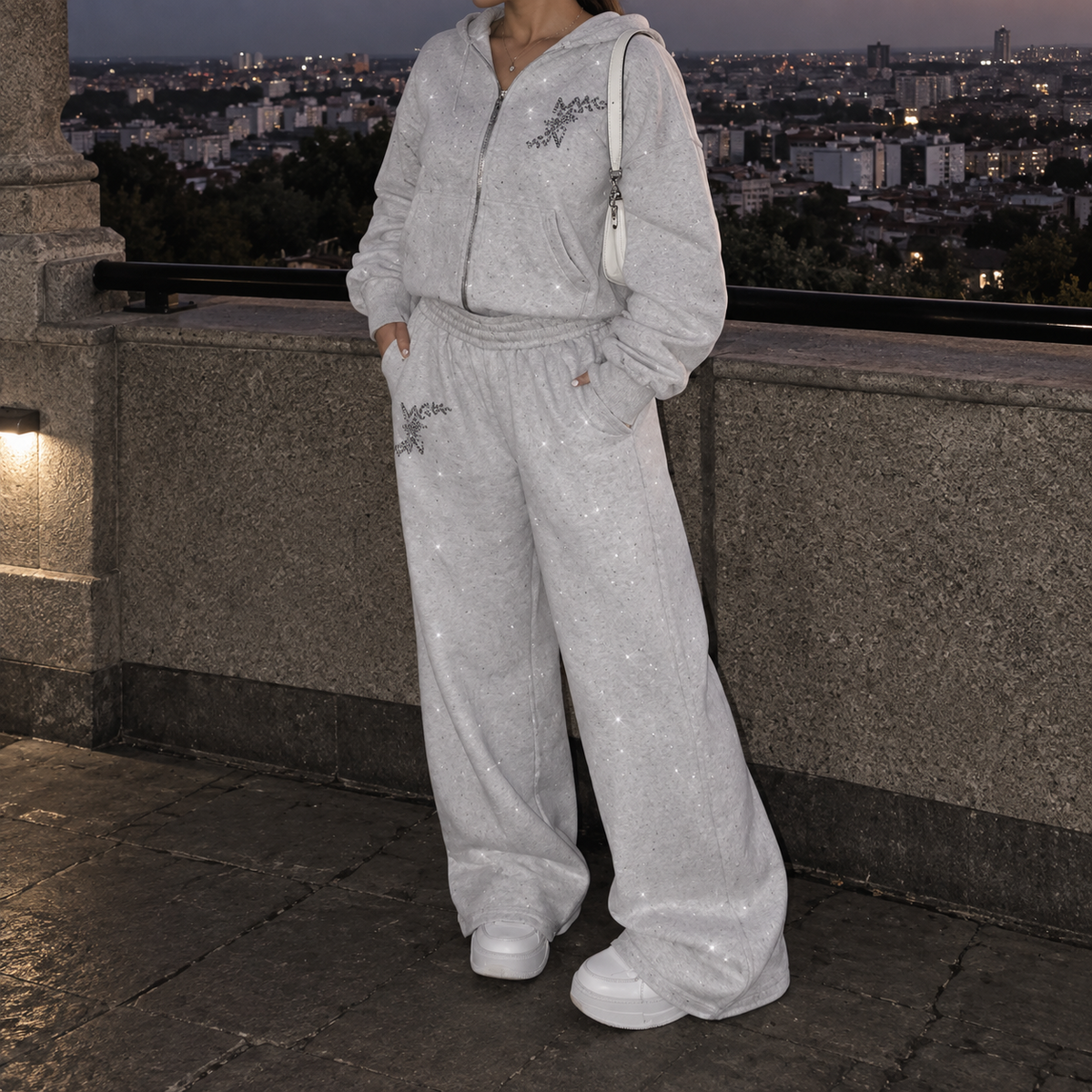 Model wearing M&N Orgullo gray rhinestone sweatpants with matching hoodie